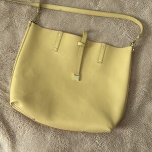 Beautiful Tiffany & Company bag in a tan yellow color and gorgeous red interior